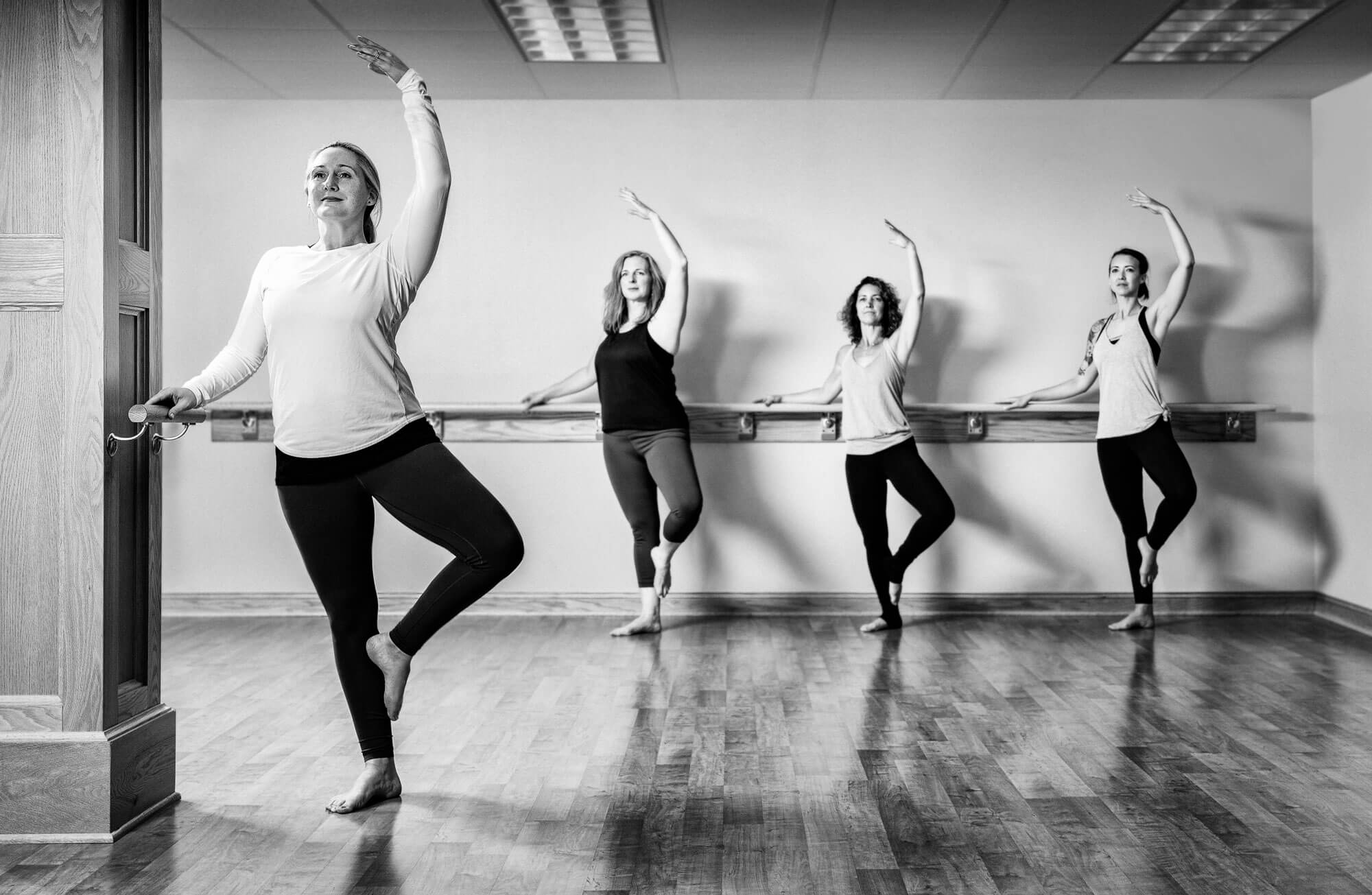 Women in a ballet studio at barre